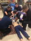 All 5 students who provided care to Lord practicing a cardiac arrest patient scenario in their lab. Photo courtesy of Gary Williams.